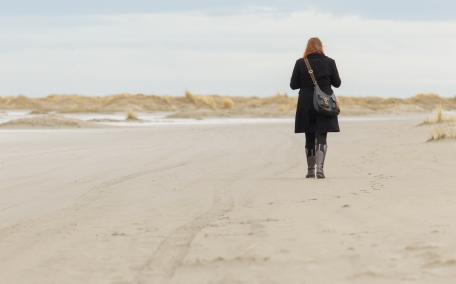 woman walking on sand